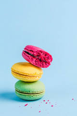 Colorful macaroons on a blue background, close-up, Flatley with copy space