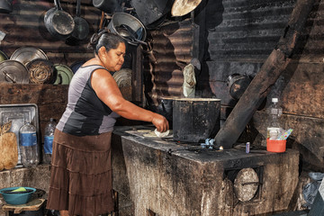 Baking tortillas on the top plate, Guatemala