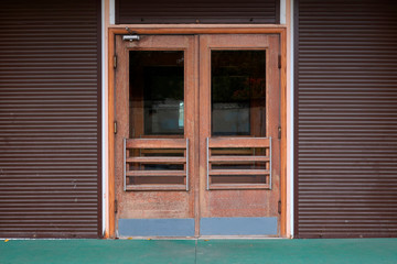 closed old double door with glass, door closer and shutters