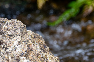 Rocks against a clear flowing stream