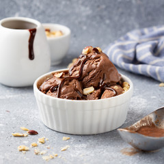 Chocolate ice cream with sauce and nuts, delicious summer dessert, sweet food