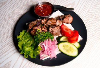 beef meat on a plate of vegetables