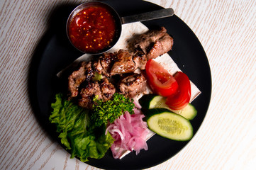 beef meat on a plate of vegetables