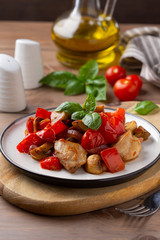 Fried chicken with vegetables (tomato, pepper, onion), mushrooms and Basil. Delicious dinner, healthy traditional food