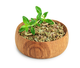 Dried thyme leaves in the wooden bowl, with fresh thyme isolated on white background