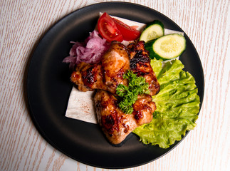 chicken wings with vegetables on a plate