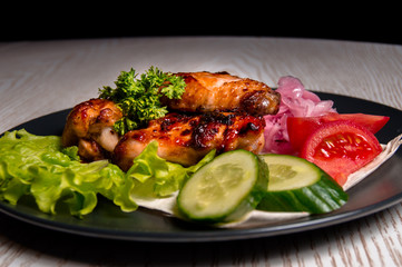 chicken wings with vegetables on a plate