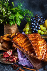 Roasted homemade pork ribs with baked crispy potatoes, Delicious barbecued hot ribs on a grunge blue background