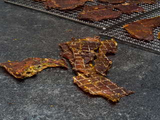 Dried meat slices on metal tray
