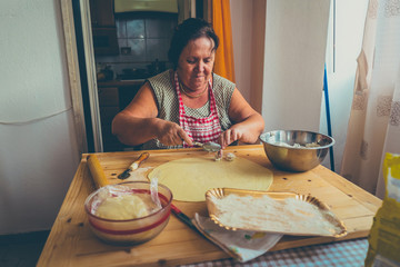 italian woman make homemade pasta ravioli on wood board