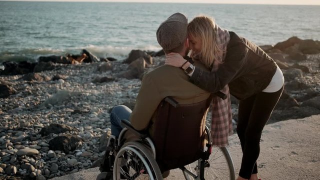 Handicapped man with girlfriend by the sea