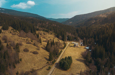 House in the Carpathian Mountains sunny spring day forest blue sky shooting on quadcopter