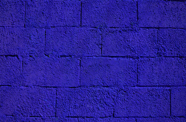 Deep purple paint on a block wall backdrop