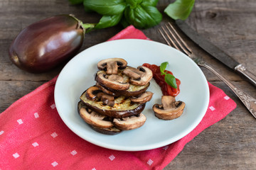 Grilled eggplant slices layered with mushrooms.