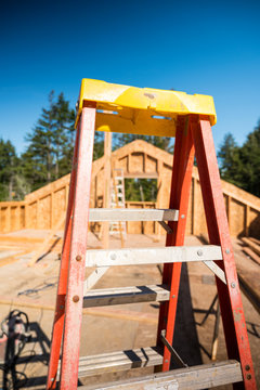 Ladder at a new home construction site, building concept image