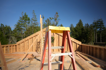 Ladder at a new home construction site, building concept image