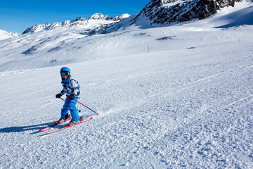 Fototapeta na wymiar Happy people, children and adults, skiing on a sunny day in Tyrol mountains