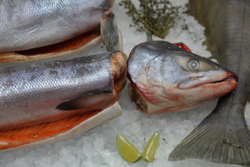 Fresh raw fish on store shelve with ice