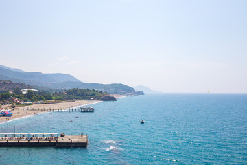 Sunny Alanya beach in Turkey with sea view. Konakli old town View from the fortress on the...
