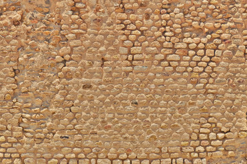 Texture stones of limestone stones brickwork. The background of vintage bricks from sandstone dating from the Roman era