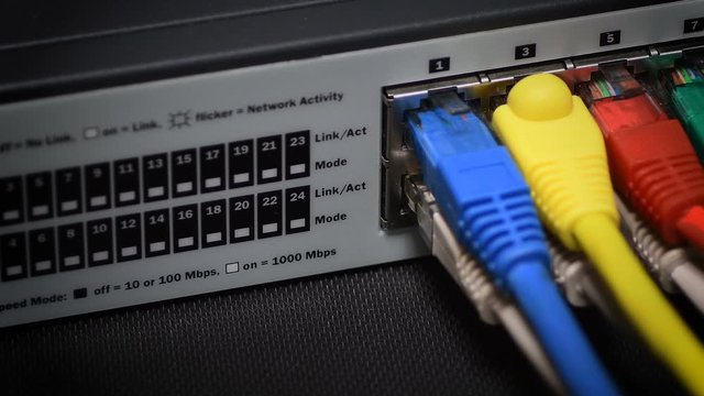 Detail of RJ45 Lan cable on network switch in data center. 4K UHD Video with pan camera movement.