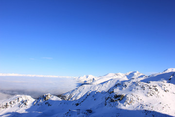 Fototapeta na wymiar skyline with snow-covered mountains under blue sky