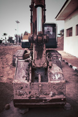 Fototapeta na wymiar Chain excavator with dirty bucket on the construction area
