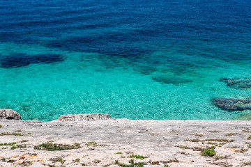 Stone beach on Proizd Island near Korcula Island, Dalmatia, Croatia, blue lagoon, clear emerald sea water, popular tourist destination  