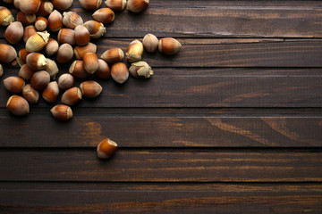Ripe hazelnuts on wooden background