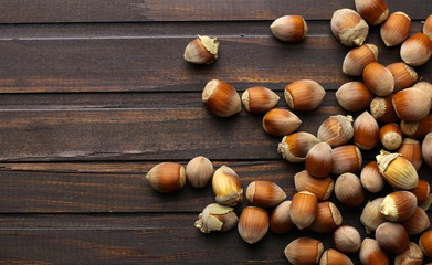 Ripe hazelnuts on wooden background