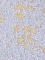Old cracked wall with burnt out in the sun and peeling paint layers
