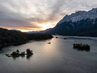 Fototapeta premium Aerial of the Eibsee lake and Zugspitze mountain in Bavaria, Germany at sunrise