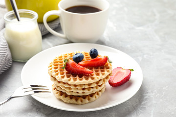 Tasty breakfast with wafers served on light grey marble table
