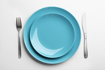 Elegant table setting on white background, top view