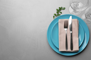 Elegant table setting on grey background, top view. Space for text