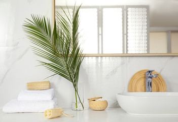 Fototapeta premium Tropical palm leaves in stylish bathroom interior