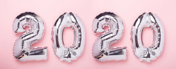 Silver balloons in the form of numbers 2020 on pink background. New year celebration. Air Balloons. Happy New Year concepts. Horizontal banner- Image