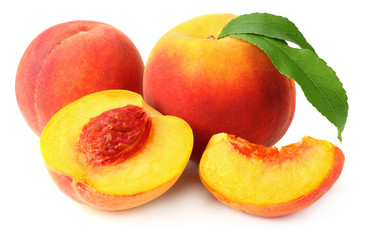 peach fruit with green leaves and slices isolated on white background