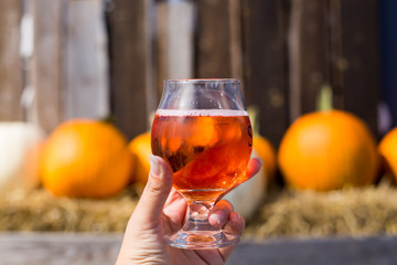 Fresh apple cider in a glass, pumpkin, halloween and fall mood background