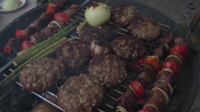 Outdoor grill with beef and vegatables in slow motion. 
