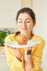 Thanksgiving girl in yellow sweater at home in the kitchen with baked apples