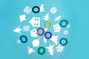 Circle with Christmas decorations and figures of houses, Christmas trees and snowflakes on blue background