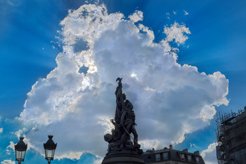 Fototapeta na wymiar A cloudburst behind the sculpture in place de Clichy