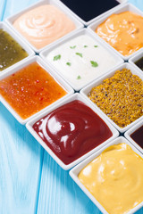 Set of different sauces in ceramic bowl