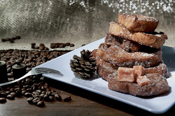 Sweet bread, milk, egg, known as Brazilian french toast. Traditional at Christmas dinner. Torrijas, traditional in spanish holy week. White dish background. Seen up close.Horizontal.
