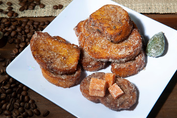 Brazilian french toast. Sweet bread, traditional at Christmas dinner.Torrijas, traditional in Spanish Holy Week. White dish background. Seen up close.Horizontal.