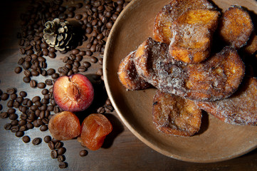 Brazilian Christmas dinner. French toast, plum fruit, dried apricot. Brazilian Christmas tradition. Brown background. Seen from above. Closely. Horizontal.