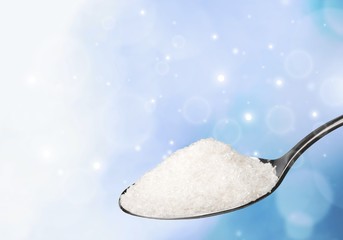 Spoon full of salt on white background