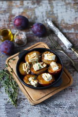 Baked plums with feta cheese. French cuisine Healthy organic food.