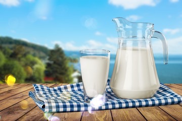Glass of milk and bottle on  background